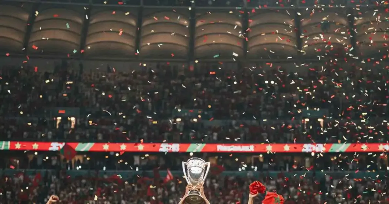 Morocco players celebrating Arab Cup victory with fans in stadium